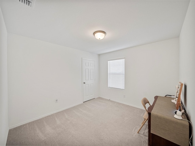 office space featuring light carpet, baseboards, and visible vents