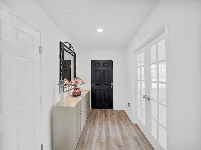 doorway featuring french doors and light wood finished floors