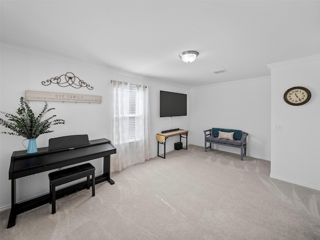 sitting room with ornamental molding, light carpet, visible vents, and baseboards