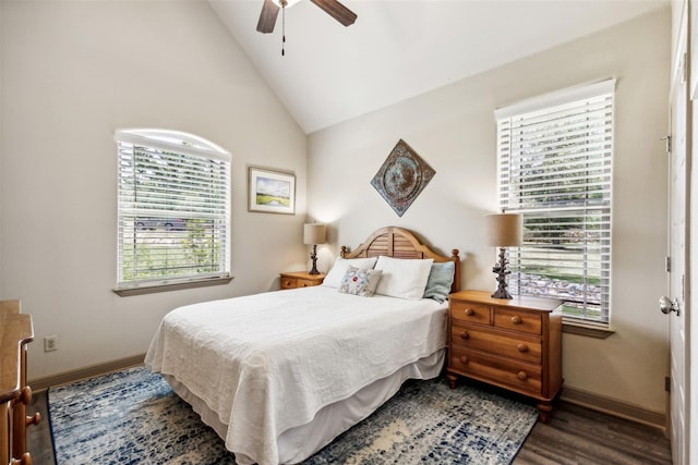 bedroom featuring lofted ceiling, dark wood finished floors, baseboards, and ceiling fan