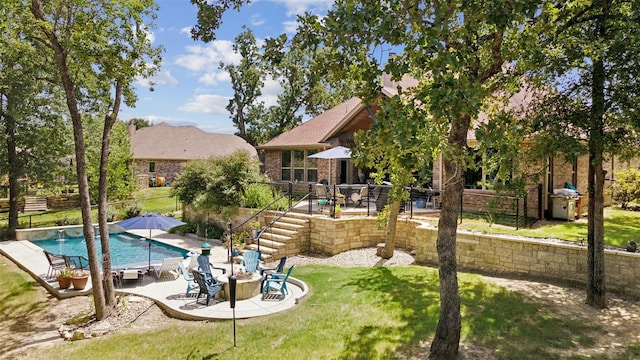 view of pool featuring a fenced in pool, a lawn, stairway, and fence