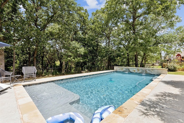 outdoor pool featuring a patio area and fence