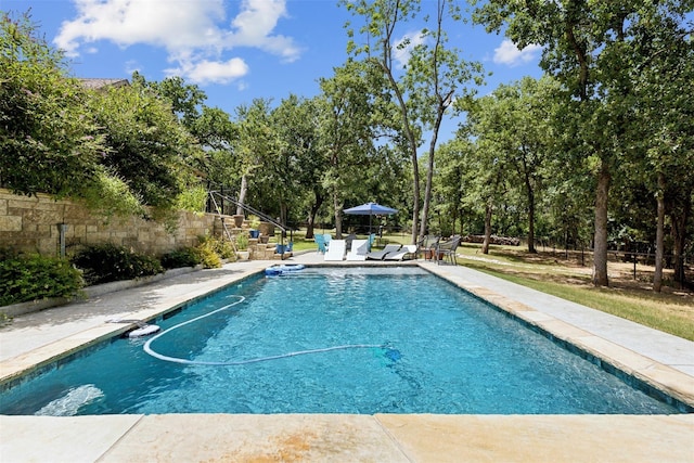 view of pool featuring fence, a fenced in pool, and a patio