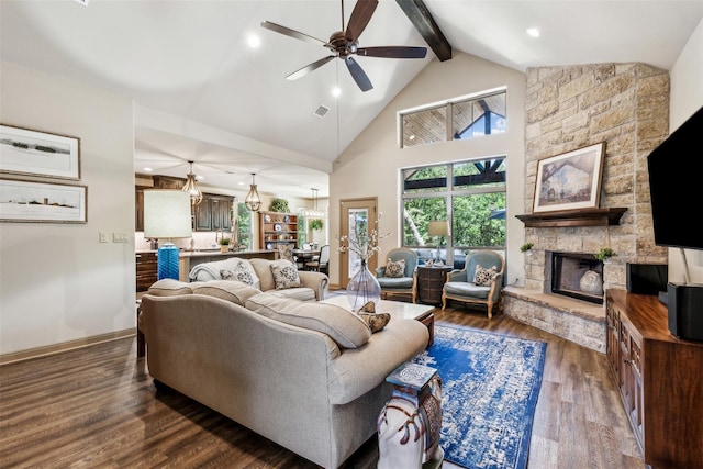 living area with beam ceiling, a fireplace, dark wood finished floors, high vaulted ceiling, and baseboards