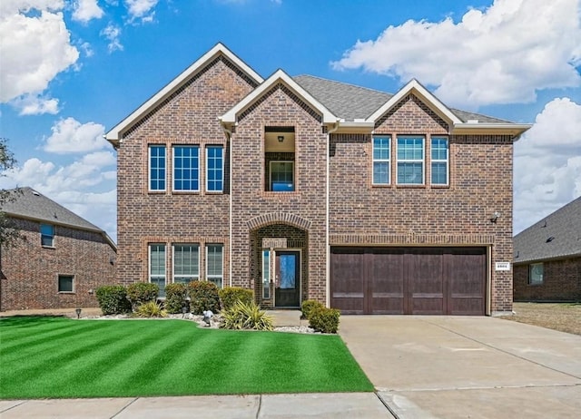 2601 Sabine Cir, Royse City, TX 75189 - view of front of property with brick siding, an attached garage, a front lawn, and driveway