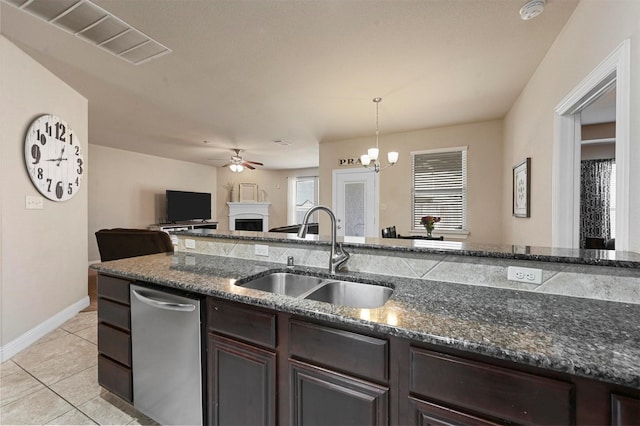 2601 Sabine Cir, Royse City, TX 75189 - kitchen with a sink, dishwasher, a fireplace, ceiling fan, and dark brown cabinetry
