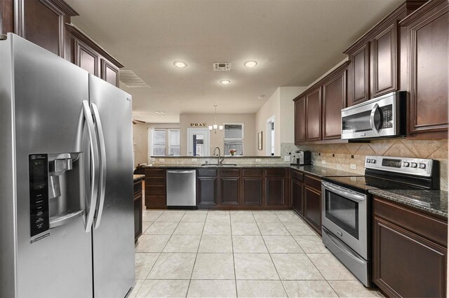2601 Sabine Cir, Royse City, TX 75189 - kitchen featuring stainless steel appliances, tasteful backsplash, recessed lighting, light tile patterned floors, and a peninsula