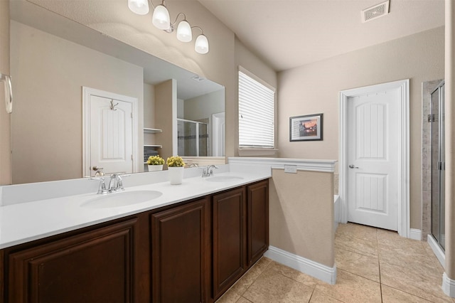 2601 Sabine Cir, Royse City, TX 75189 - full bath featuring a shower stall, double vanity, tile patterned floors, baseboards, and a bath