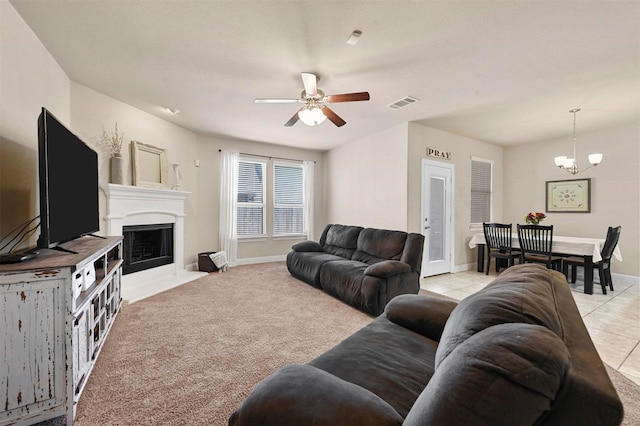 2601 Sabine Cir, Royse City, TX 75189 - living area with ceiling fan, a fireplace with flush hearth, a chandelier, baseboards, and light colored carpet