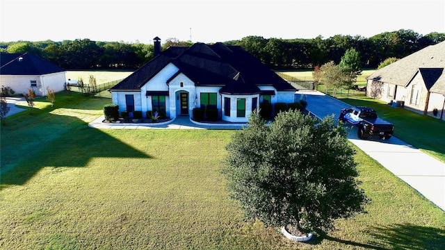 exterior space featuring a front lawn and fence