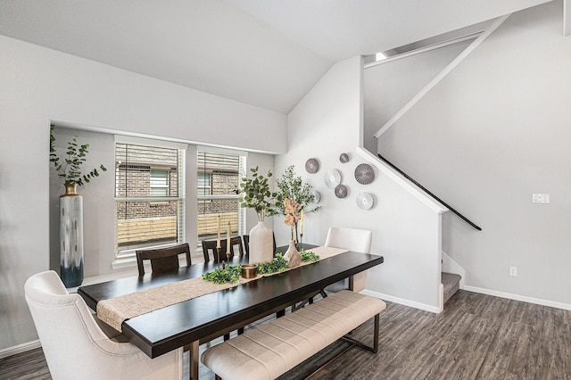 dining space with lofted ceiling, stairs, baseboards, and dark wood finished floors