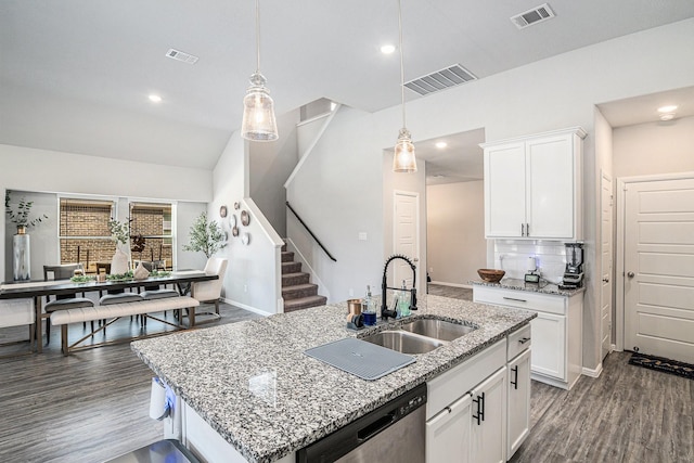 kitchen with stainless steel dishwasher, visible vents, white cabinets, and a sink