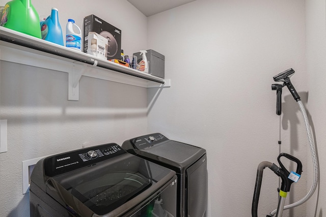 clothes washing area featuring washing machine and dryer and laundry area