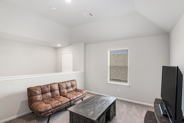 living area featuring lofted ceiling, baseboards, visible vents, and carpet flooring