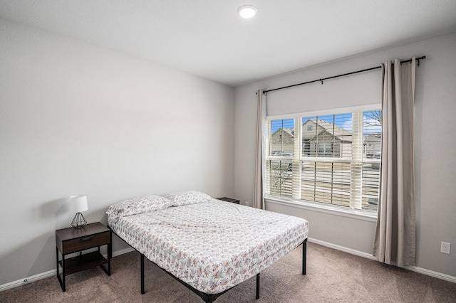 carpeted bedroom featuring baseboards