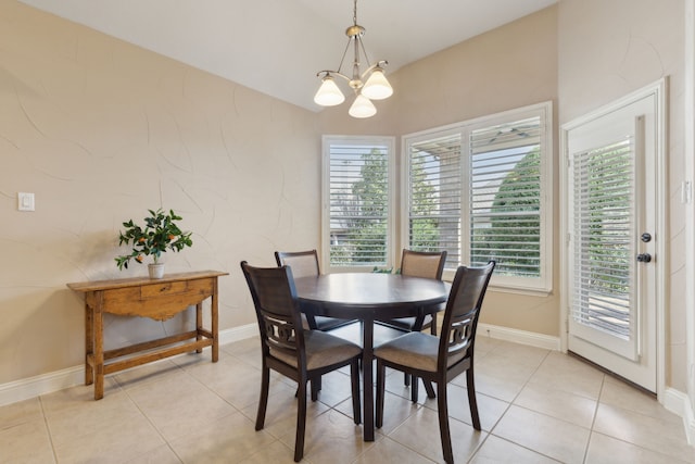 dining room featuring light tile patterned floors, baseboards, and a notable chandelier