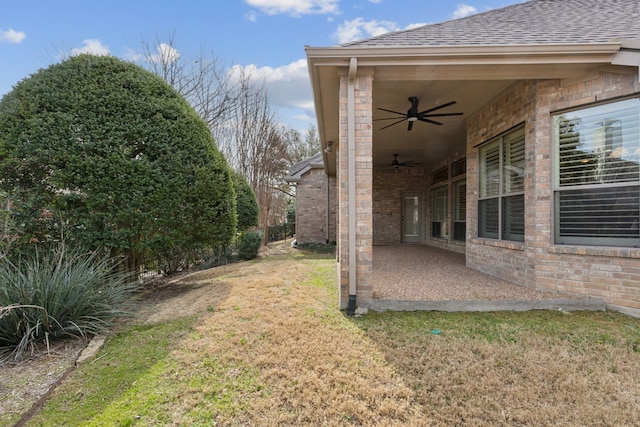 view of yard with a patio area and a ceiling fan