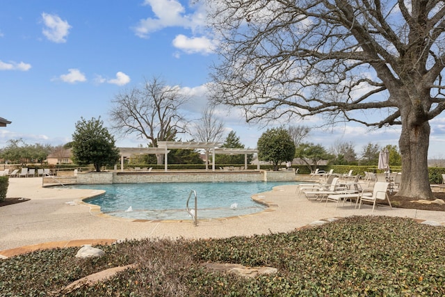 pool with a patio area and a pergola