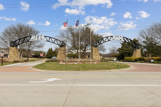 view of road featuring curbs and traffic signs