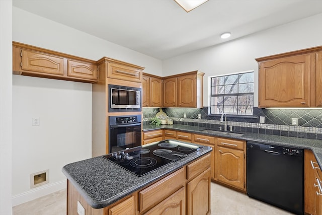 kitchen with a kitchen island, decorative backsplash, black appliances, and a sink