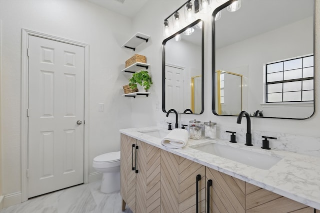 full bath with double vanity, toilet, marble finish floor, and a sink