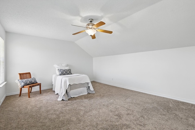 carpeted bedroom featuring baseboards, a textured ceiling, lofted ceiling, and a ceiling fan