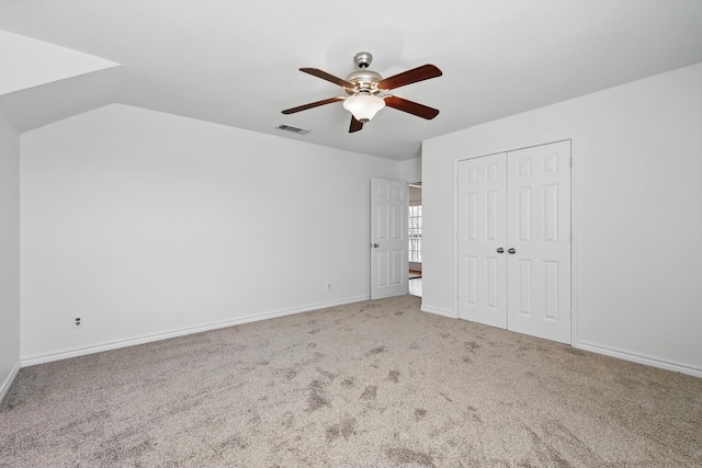 unfurnished bedroom featuring visible vents, baseboards, carpet flooring, a closet, and a ceiling fan