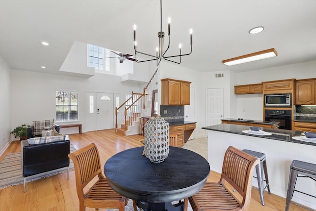 dining space with stairs, recessed lighting, visible vents, and light wood finished floors