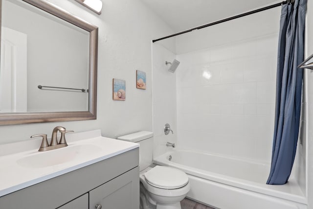 bathroom with shower / bathtub combination with curtain, toilet, and vanity