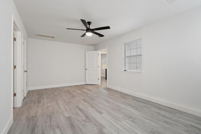 unfurnished bedroom with visible vents, ceiling fan, light wood-style flooring, and baseboards