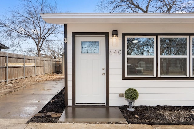 entrance to property featuring fence