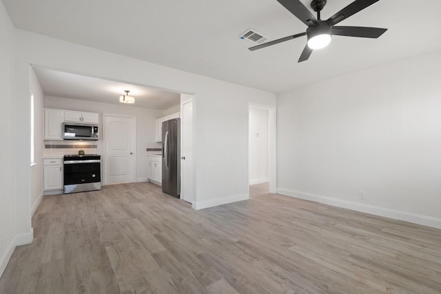 kitchen with light wood-style flooring, visible vents, white cabinetry, light countertops, and appliances with stainless steel finishes