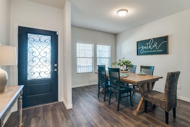 dining room featuring baseboards and dark wood finished floors