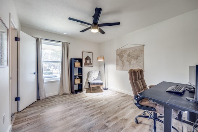 office area with ceiling fan, baseboards, and wood finished floors