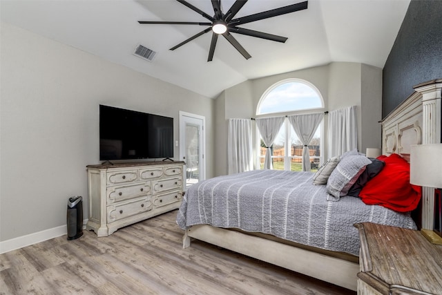 bedroom featuring visible vents, baseboards, a ceiling fan, light wood-style flooring, and vaulted ceiling