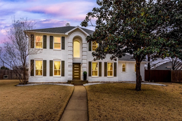 2702 Kingsbury Dr, Garland, TX 75040 - view of front of property with a front yard, fence, and brick siding