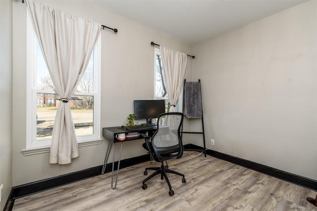 office featuring light wood-type flooring and baseboards