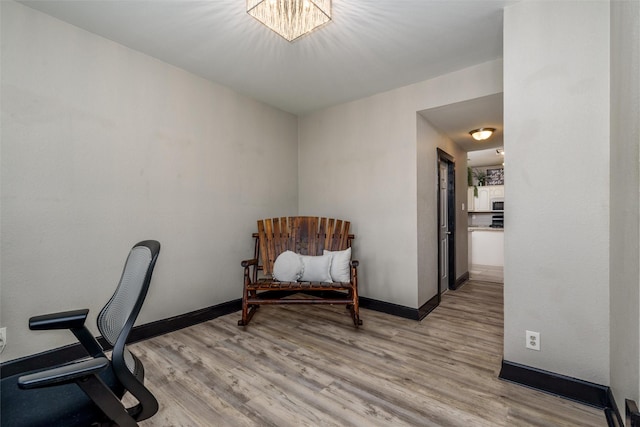 office space featuring baseboards and light wood-style floors