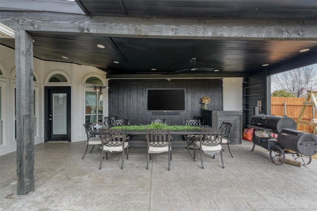 view of patio / terrace with fence, grilling area, a ceiling fan, and outdoor dining space