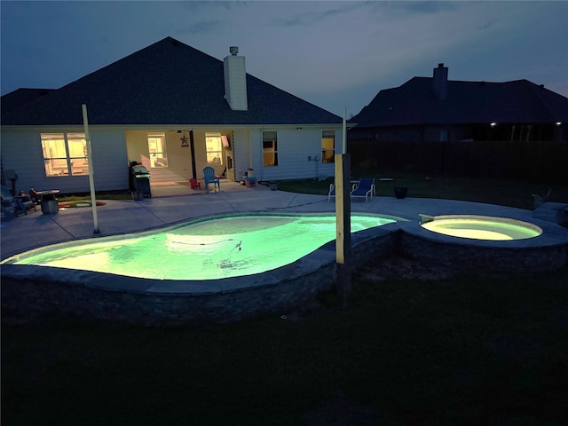 view of swimming pool with a patio, an in ground hot tub, fence, and a fenced in pool