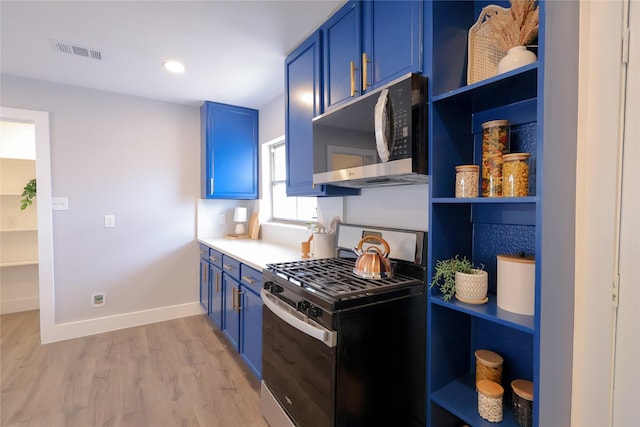 kitchen with stainless steel appliances, visible vents, blue cabinetry, and open shelves