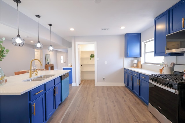 kitchen featuring stainless steel appliances, light countertops, and blue cabinetry