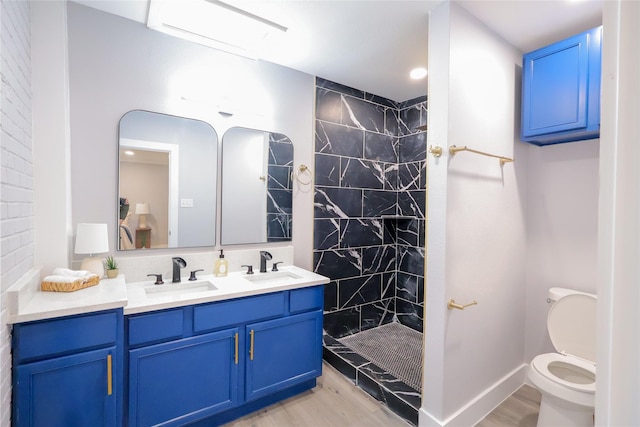 full bath with a sink, toilet, and wood finished floors