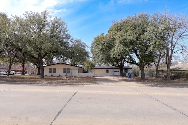 ranch-style home with concrete driveway