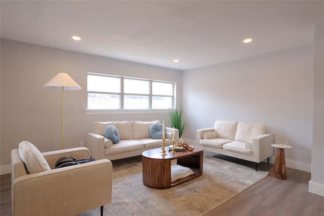 living area featuring recessed lighting, baseboards, and wood finished floors