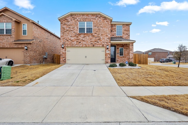 view of front facade with an attached garage, fence, concrete driveway, and brick siding