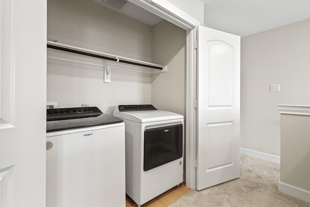 laundry room featuring light carpet, laundry area, visible vents, baseboards, and washing machine and clothes dryer