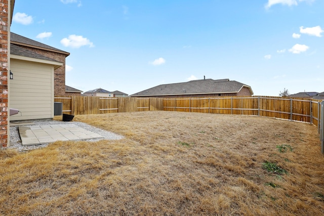 view of yard featuring a patio area and a fenced backyard