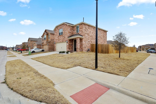 view of front of house featuring driveway, a residential view, an attached garage, fence, and brick siding