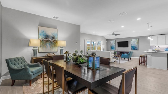 dining area with light wood-type flooring, visible vents, and recessed lighting